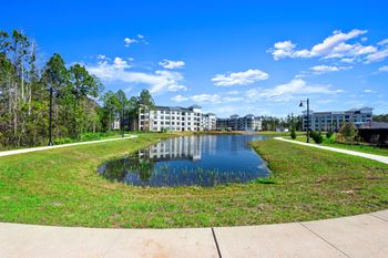 a large pond with a building in the background